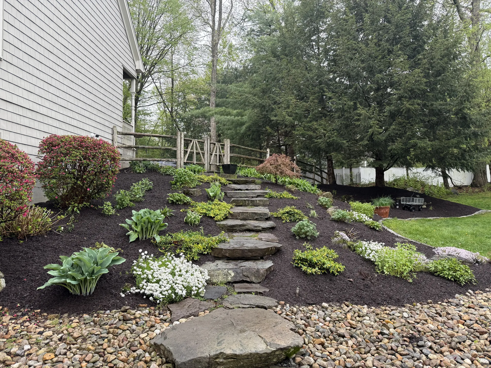 Stone step garden path through mulched hillside